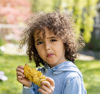 Boy Eating Elote